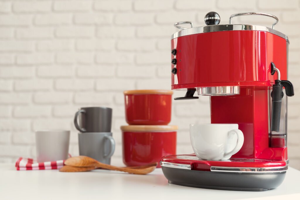 Modern kitchen. Red retro style coffee machine close up